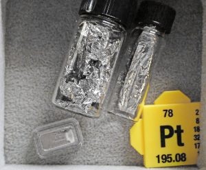 Ligotavý kov striebornej farby v skúmavke so žltým štítkom označujúcim platinu