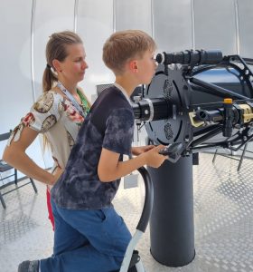 Mladí žiaci používajú teleskop