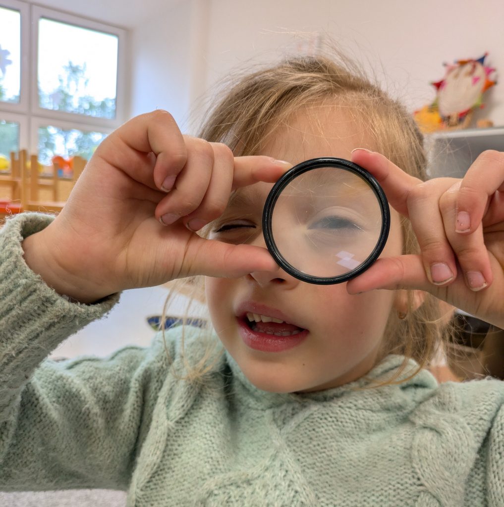 Dieťa pozerá cez šošovku